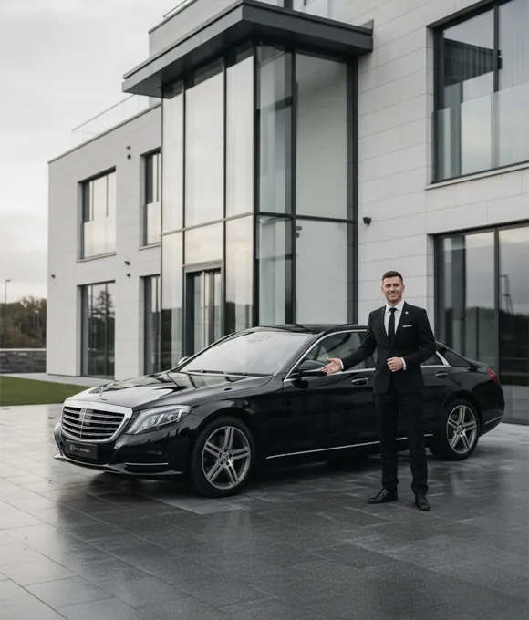 Apache Travels chauffeur standing beside a Mercedes S-Class